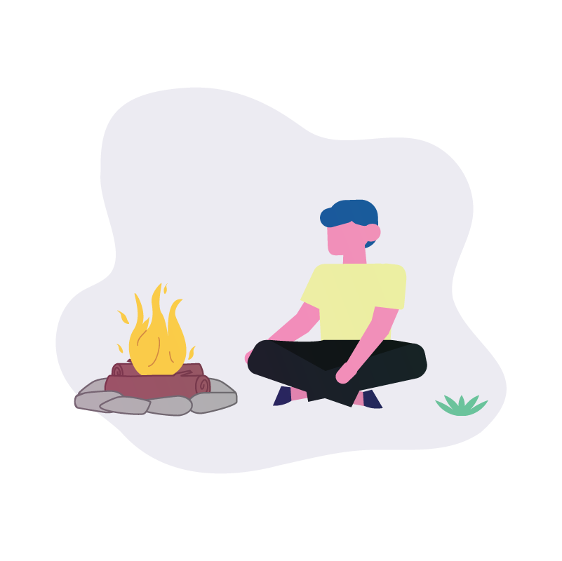 a man sitting next to a campfire